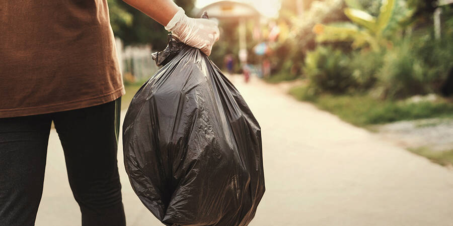 holding bag of garbage